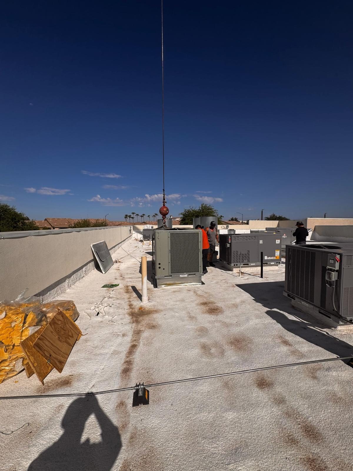New rooftop HVAC unit set by crane on the foam roof