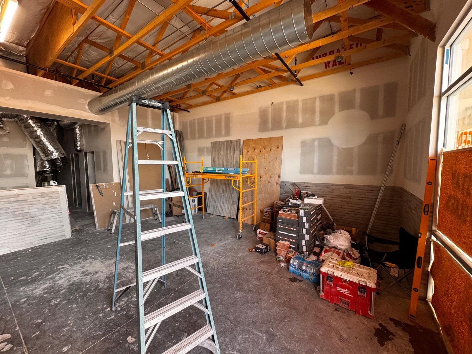 Dining room with exposed trusses, spiral duct and wainscot going in
