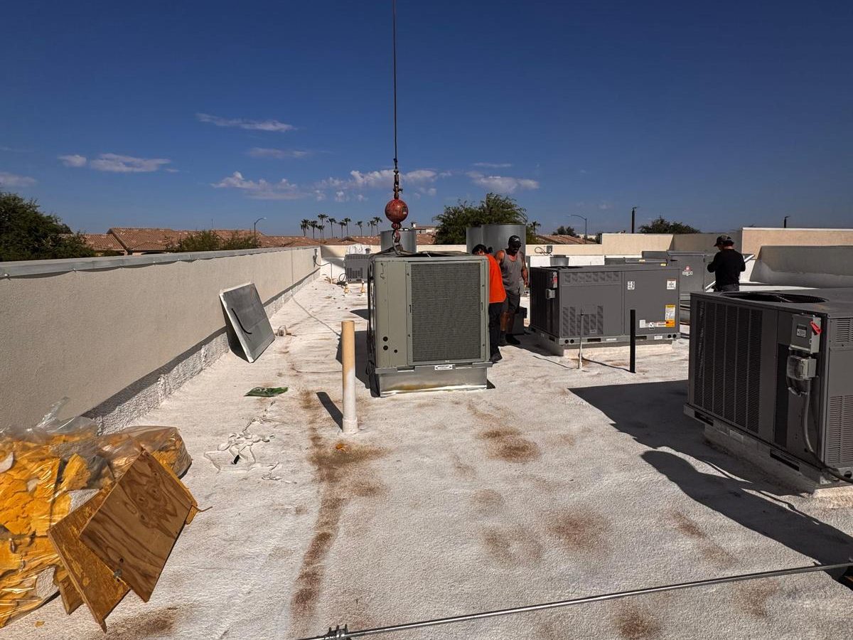 MIRAI Constructions crew setting a new rooftop AC unit by crane under the Arizona sun