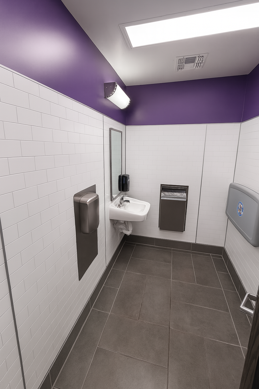Restroom finished in white subway tile