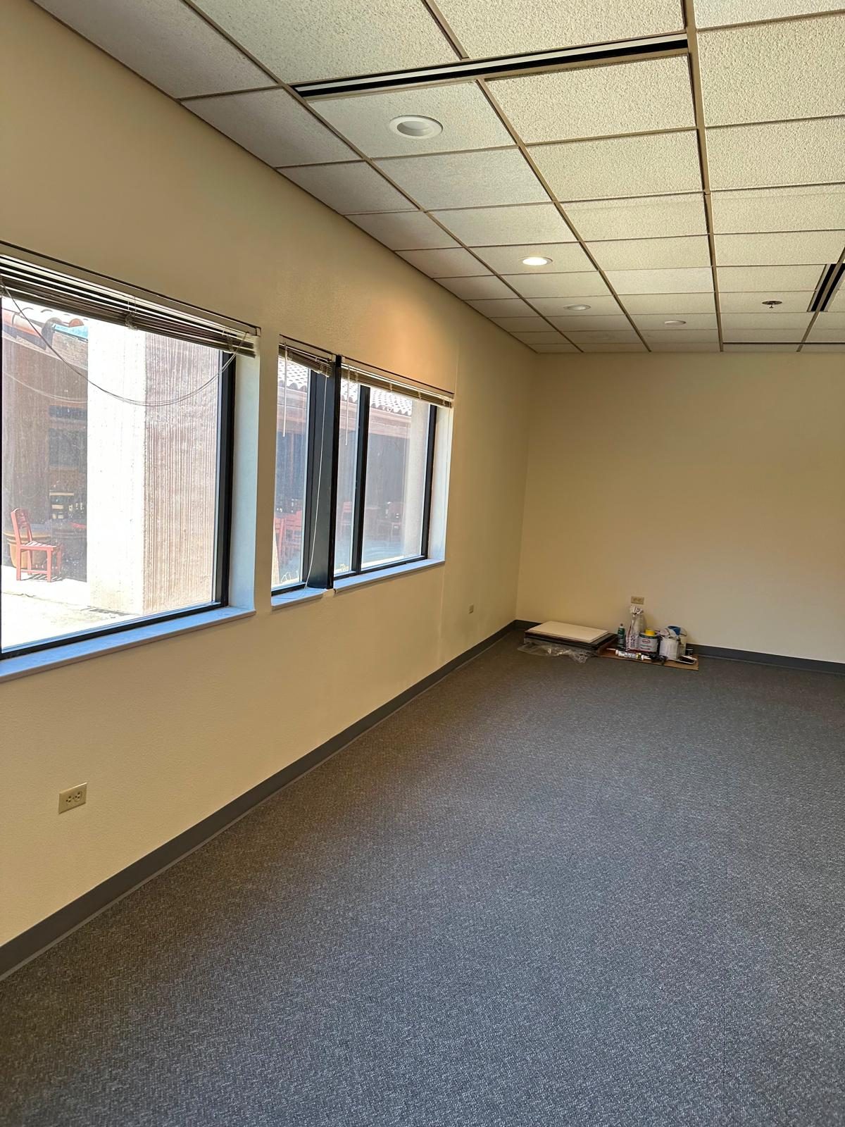 Office with a row of windows, carpet and base finished