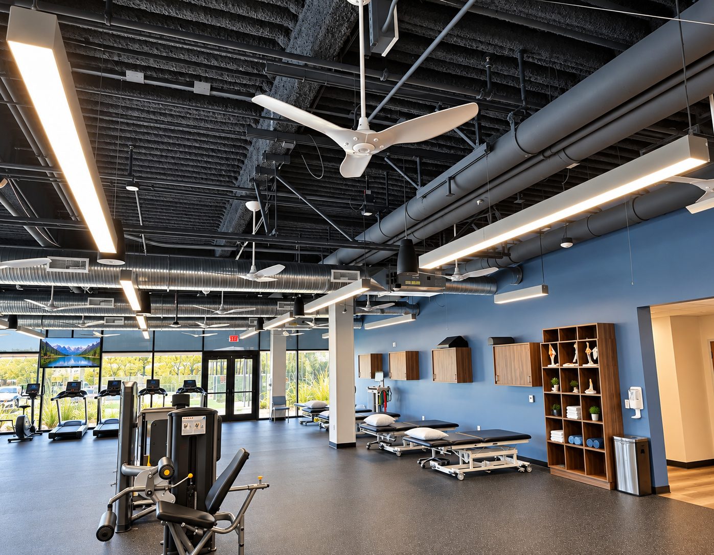 Strength machines in front of the treatment tables and wall-mounted casework