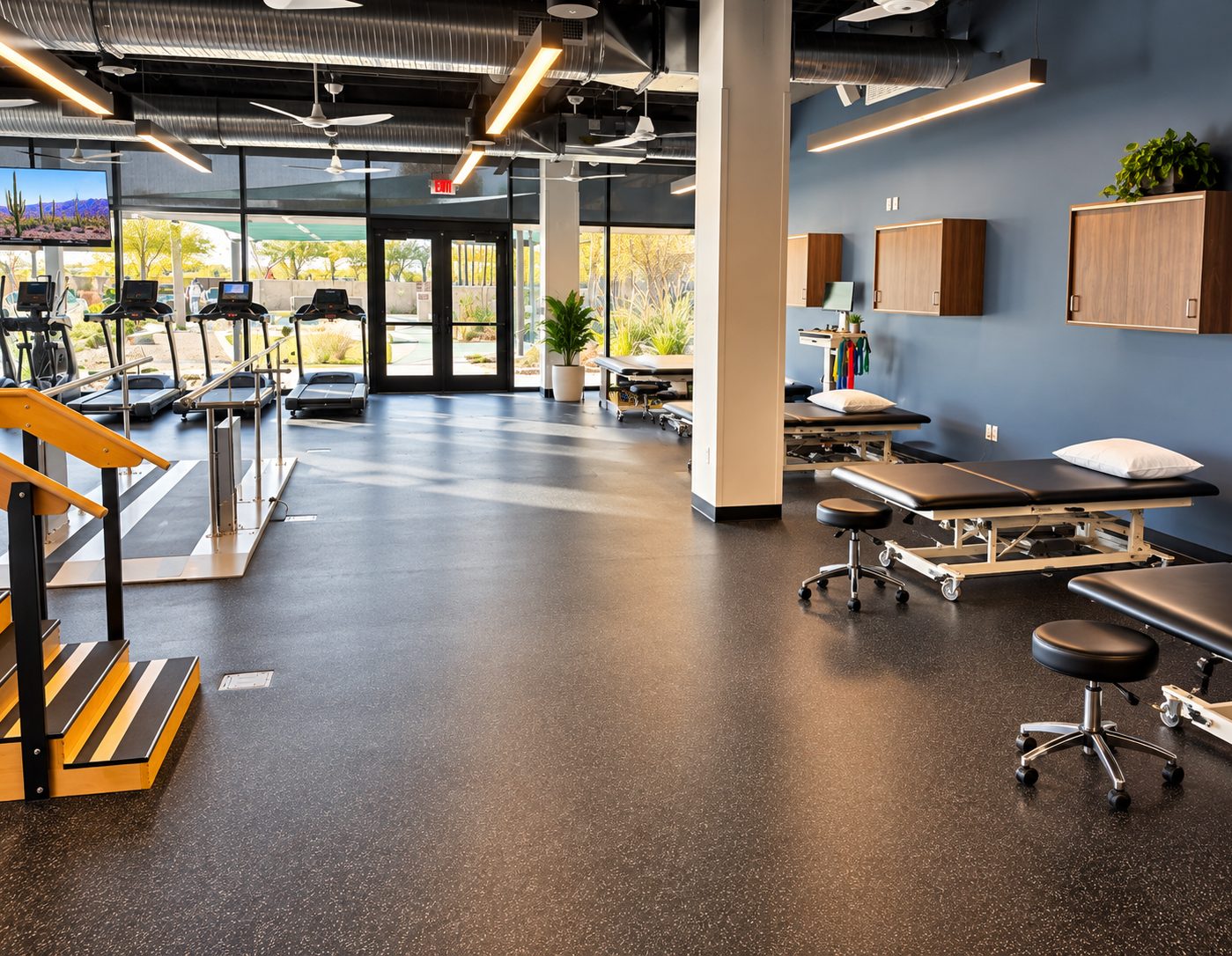 Training stairs and parallel bars beside the treatment tables